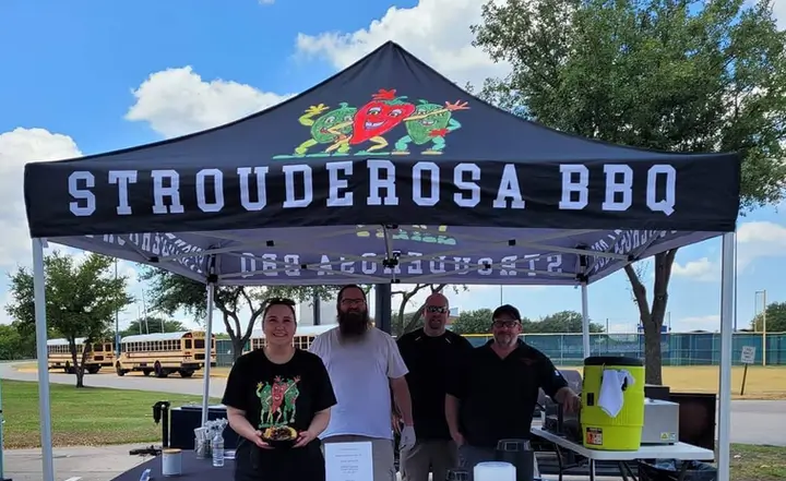 A party gathered around the table at Strouderosa BBQ